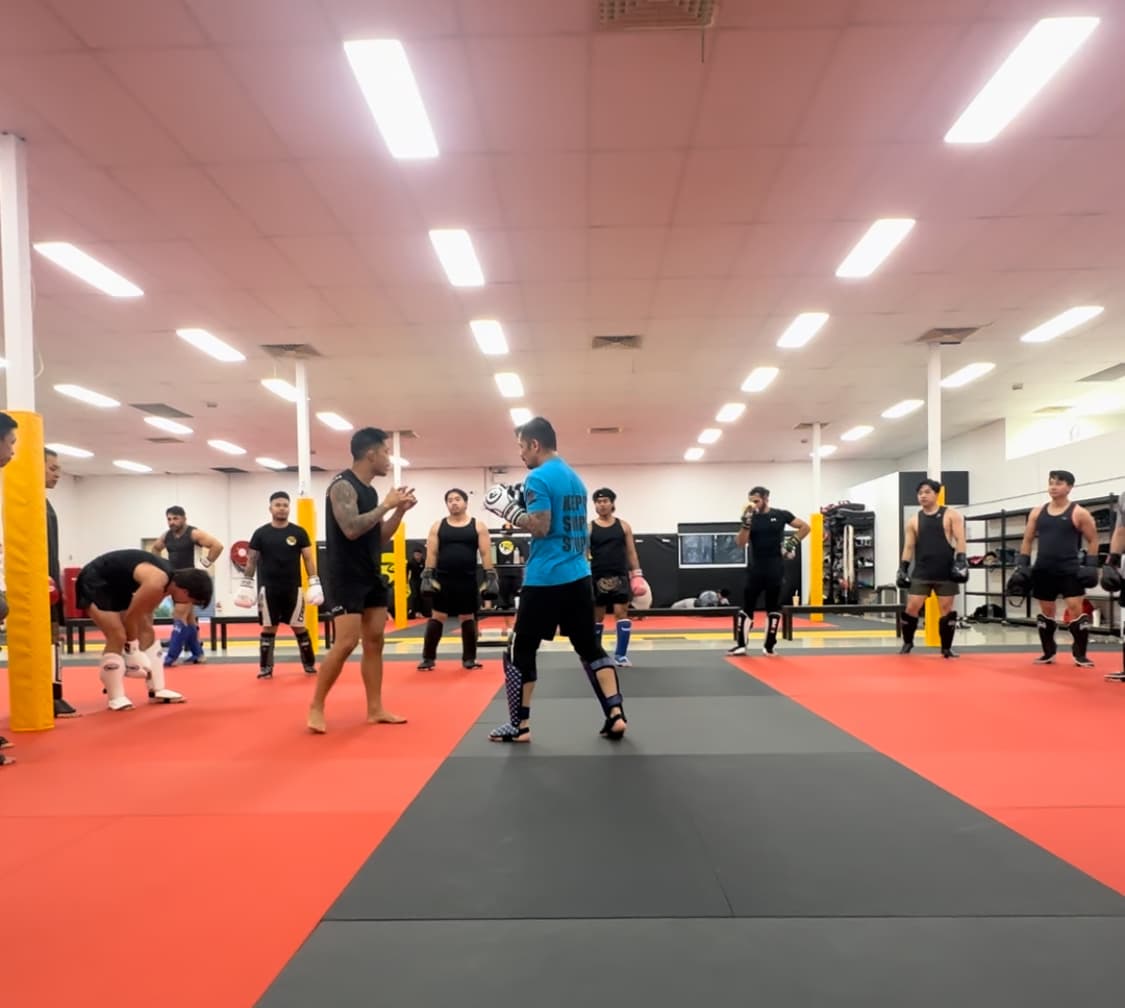 Two members standing opposite in kickboxing stance